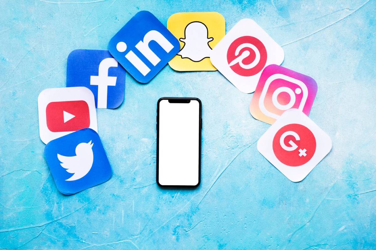 Smartphone surrounded by social media icons on a textured blue background. 
